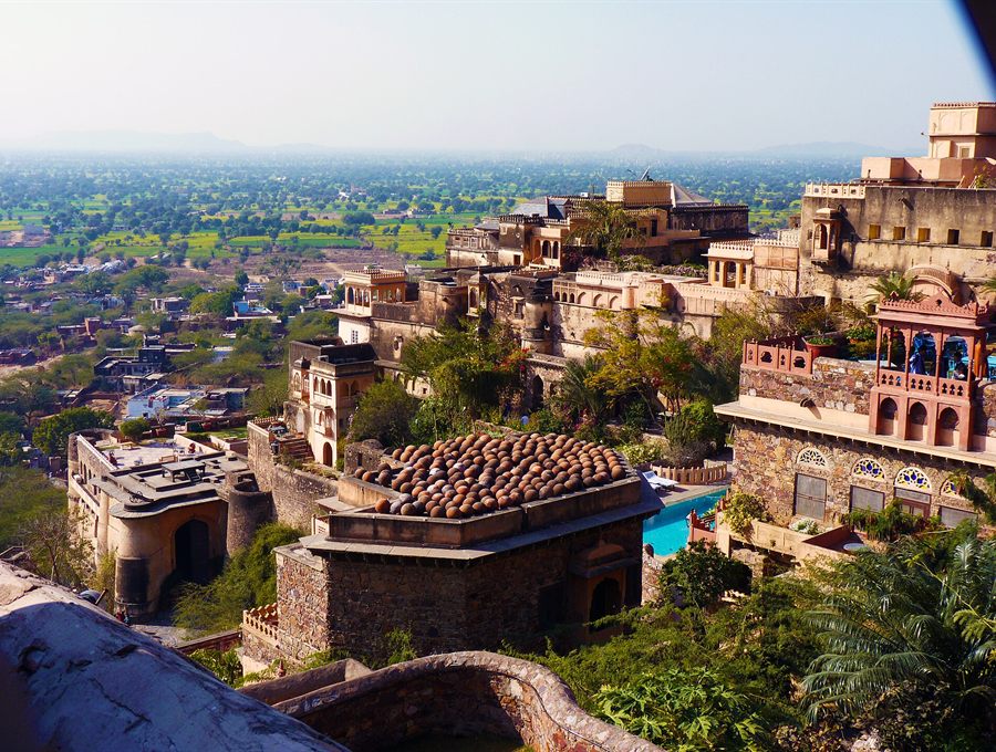 Hilltop fort palace with terraced courtyards overlooking green countryside