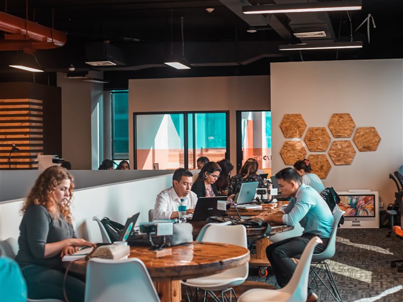 Relaxed coworking lounge with sofas and communal work tables
