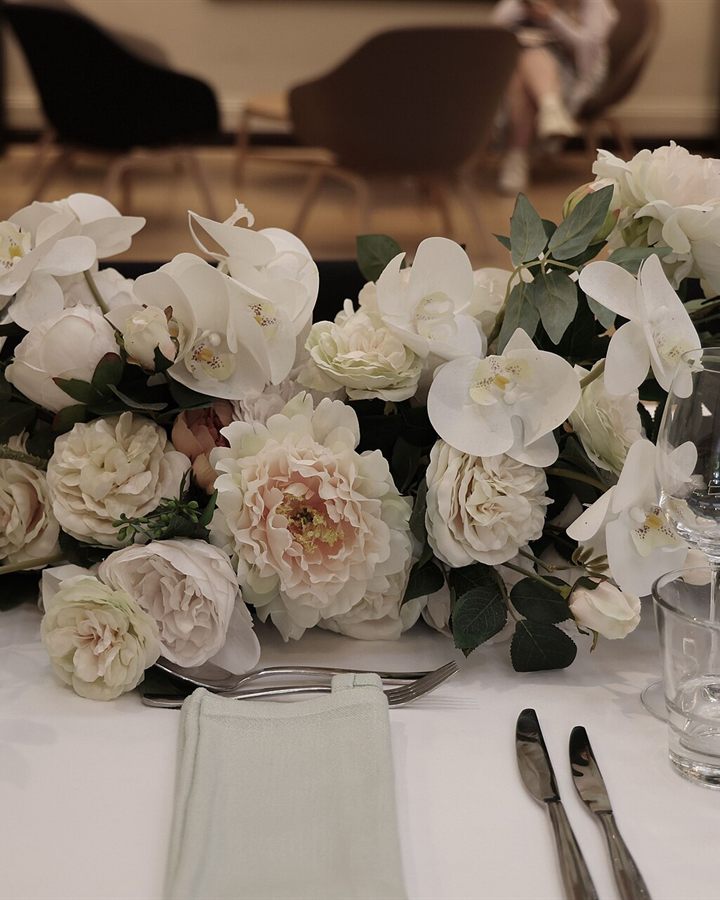 Luxury wedding table styled with white roses and orchids
